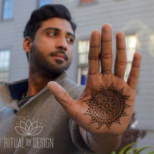 The groom holding the hand of the bride with henna mehndi at the wedding  ceremony Stock Photo - Alamy