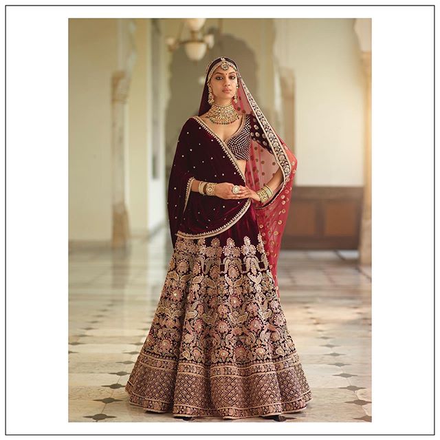 Photo of Maroon and gold bridal lehenga for winter wedding